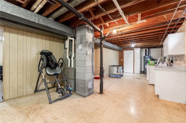5603 170th St, Chippewa Falls, WI 54729 - unfinished basement with light floors, washing machine and clothes dryer, water heater, heating unit, and wood walls