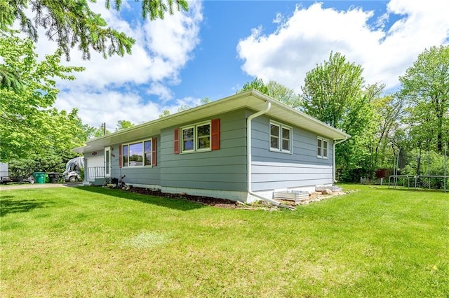 5603 170th St, Chippewa Falls, WI 54729 - view of property exterior with a lawn and a trampoline