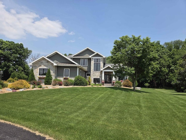 1102 Eldon Way, Edgerton, WI 53534 - craftsman house with stone siding and a front lawn