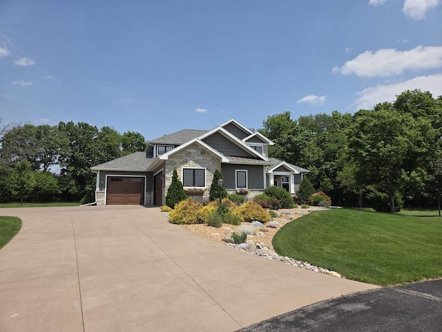 1102 Eldon Way, Edgerton, WI 53534 - craftsman house with stone siding, concrete driveway, an attached garage, and a front lawn