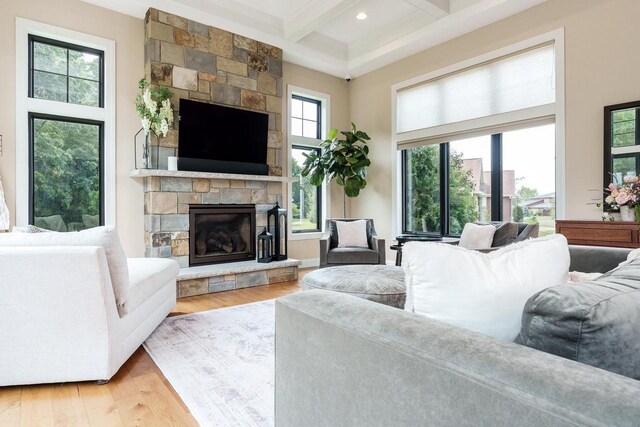 1102 Eldon Way, Edgerton, WI 53534 - living area featuring beamed ceiling, light wood-style floors, a stone fireplace, coffered ceiling, and recessed lighting