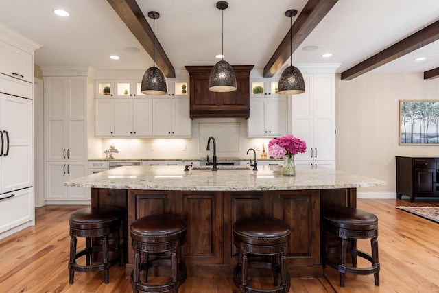 1102 Eldon Way, Edgerton, WI 53534 - kitchen featuring beamed ceiling, light wood-style floors, white cabinetry, decorative backsplash, and recessed lighting