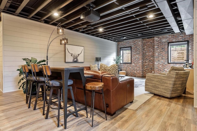 1102 Eldon Way, Edgerton, WI 53534 - cinema featuring wood finished floors, healthy amount of natural light, and brick wall