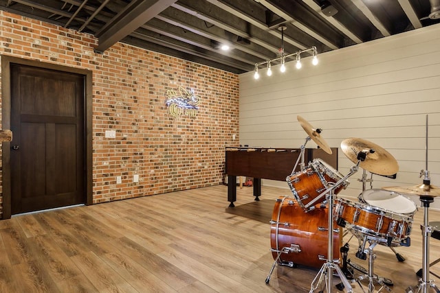 1102 Eldon Way, Edgerton, WI 53534 - misc room featuring brick wall and wood finished floors