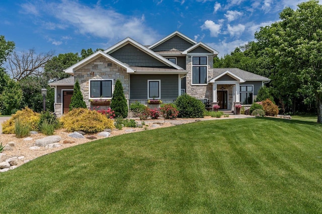 1102 Eldon Way, Edgerton, WI 53534 - craftsman-style home with stone siding and a front lawn