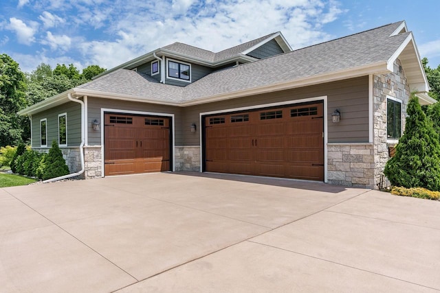 1102 Eldon Way, Edgerton, WI 53534 - craftsman-style house featuring stone siding, a shingled roof, and an attached garage