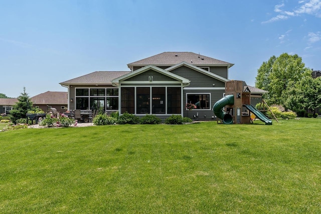 1102 Eldon Way, Edgerton, WI 53534 - rear view of house with a sunroom, a yard, a playground, and a patio area