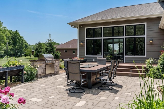 1102 Eldon Way, Edgerton, WI 53534 - view of patio / terrace with outdoor dining area and exterior kitchen