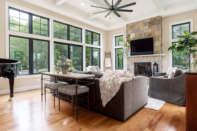 1102 Eldon Way, Edgerton, WI 53534 - living area with coffered ceiling, light wood-style flooring, a ceiling fan, beamed ceiling, and a fireplace