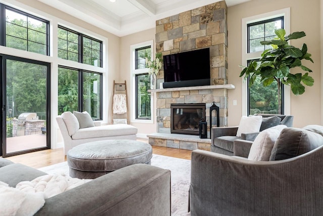 1102 Eldon Way, Edgerton, WI 53534 - living room featuring a stone fireplace, healthy amount of natural light, beamed ceiling, wood finished floors, and a high ceiling