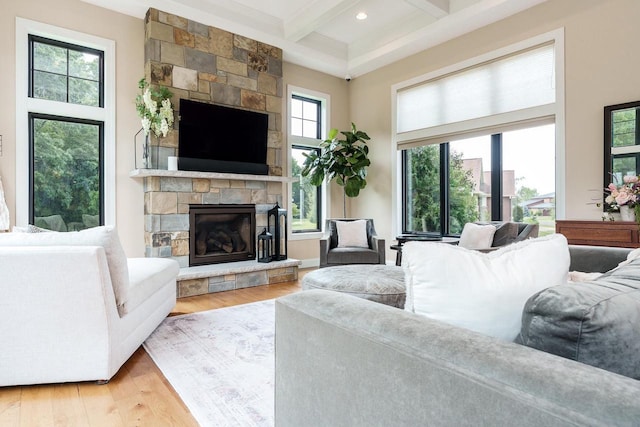 1102 Eldon Way, Edgerton, WI 53534 - living area featuring beamed ceiling, light wood-style floors, a stone fireplace, coffered ceiling, and recessed lighting