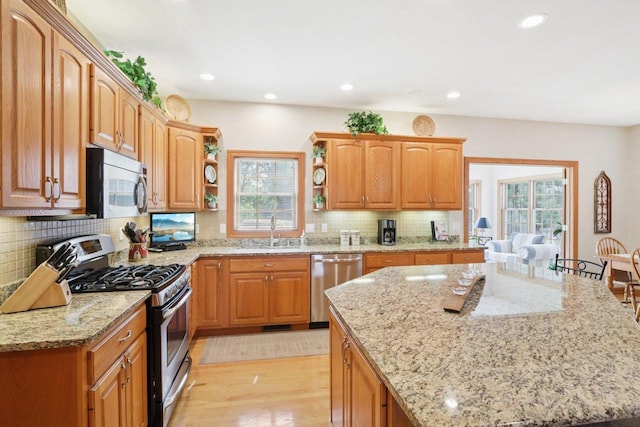 3944 Caribou Rd, Verona, WI 53593 - kitchen featuring stainless steel appliances, open shelves, healthy amount of natural light, light stone counters, and recessed lighting