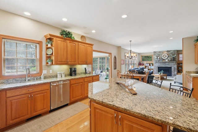3944 Caribou Rd, Verona, WI 53593 - kitchen featuring dishwasher, light wood finished floors, recessed lighting, light stone countertops, and decorative backsplash