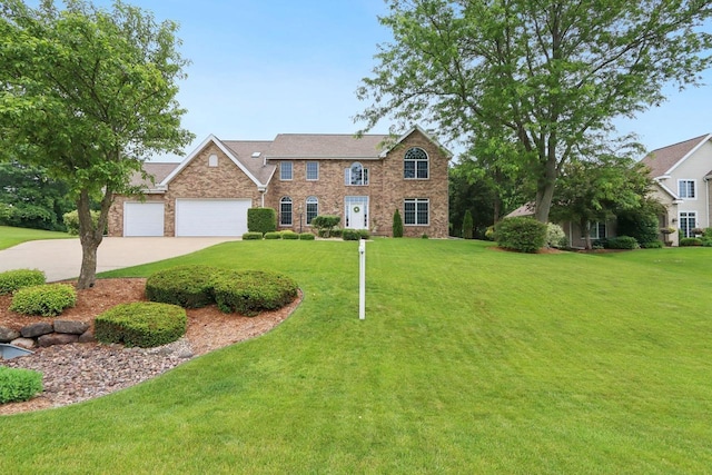 3944 Caribou Rd, Verona, WI 53593 - view of front of property featuring a front lawn, a garage, driveway, brick siding, and stone siding