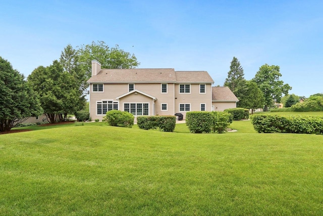 3944 Caribou Rd, Verona, WI 53593 - rear view of house featuring a lawn and a chimney