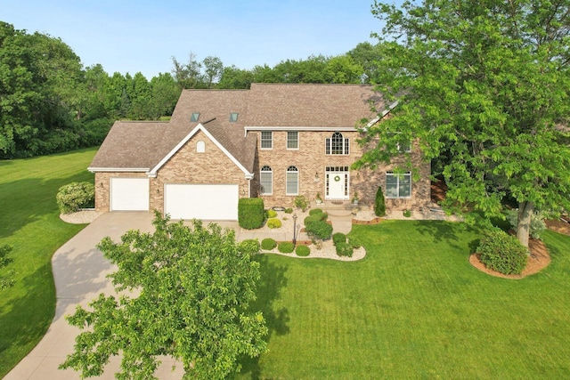 3944 Caribou Rd, Verona, WI 53593 - colonial-style house featuring a garage, concrete driveway, a front lawn, and brick siding