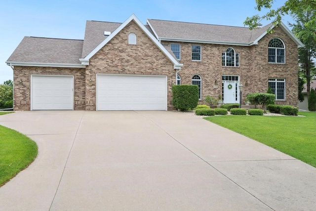 3944 Caribou Rd, Verona, WI 53593 - view of front of property featuring concrete driveway, brick siding, a shingled roof, a front lawn, and a garage