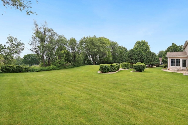 3944 Caribou Rd, Verona, WI 53593 - view of green lawn with view of wooded area and a patio area
