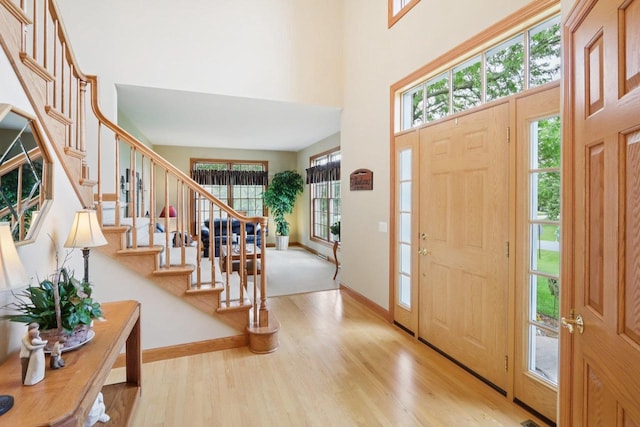 3944 Caribou Rd, Verona, WI 53593 - foyer featuring stairs, wood finished floors, and a towering ceiling