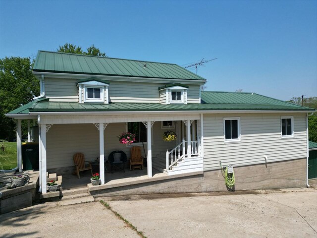 3213 W County M Rd, Edgerton, WI 53534 - rear view of property featuring metal roof and a porch