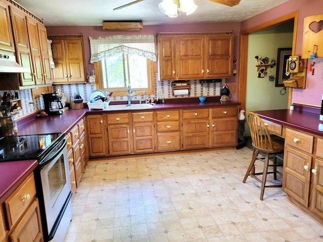 3213 W County M Rd, Edgerton, WI 53534 - kitchen with stainless steel range with electric stovetop, a sink, brown cabinets, and dark countertops