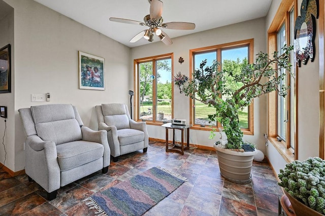 7129 S County Road Jj, Bancroft, WI 54921 - living area with baseboards, dark stone finish floors, and ceiling fan