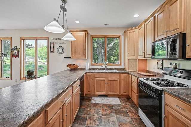 7129 S County Road Jj, Bancroft, WI 54921 - kitchen with range with gas cooktop, stainless steel microwave, a sink, dark countertops, and stone finish flooring