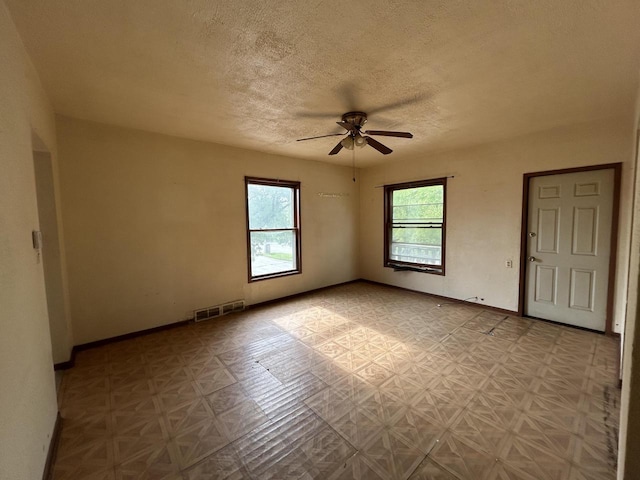 1218 W Locust St, Milwaukee, WI 53206 - spare room featuring a ceiling fan, a textured ceiling, and baseboards