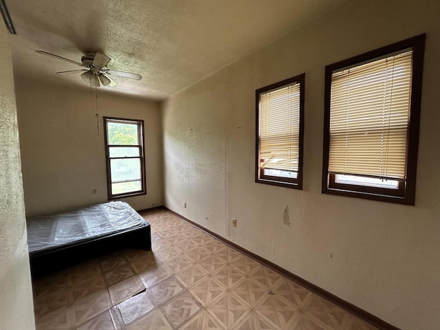 1218 W Locust St, Milwaukee, WI 53206 - bedroom with a textured ceiling, baseboards, and a ceiling fan