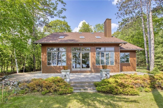 11053 N Robin Ln, Hayward, WI 54843 - back of house featuring a chimney