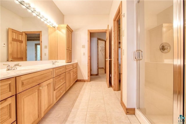 11053 N Robin Ln, Hayward, WI 54843 - full bath featuring double vanity, a stall shower, tile patterned flooring, and baseboards