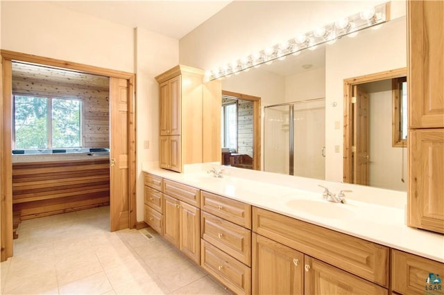 11053 N Robin Ln, Hayward, WI 54843 - bathroom with double vanity, a shower stall, and tile patterned floors