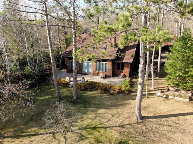 11053 N Robin Ln, Hayward, WI 54843 - back of house with a patio area and a shingled roof