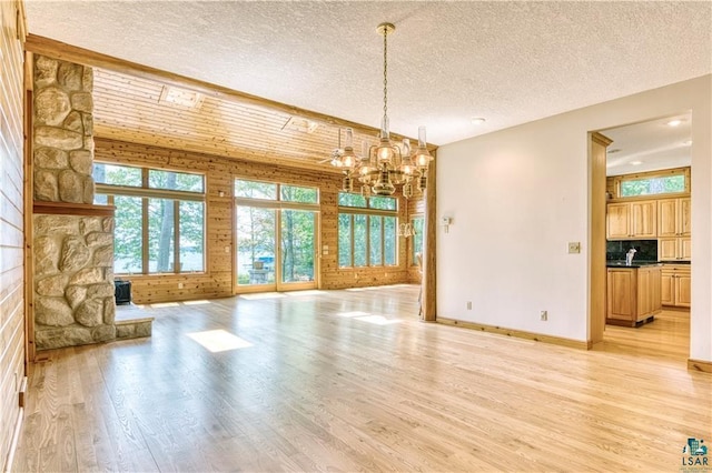 11053 N Robin Ln, Hayward, WI 54843 - unfurnished living room with light wood-style floors, a chandelier, a textured ceiling, and baseboards