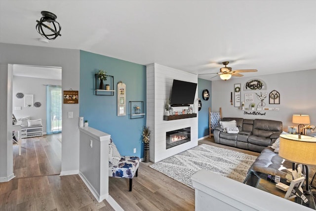 3433 Illinois St, Mount Pleasant, WI 53405 - living room featuring a ceiling fan, wood finished floors, and baseboards