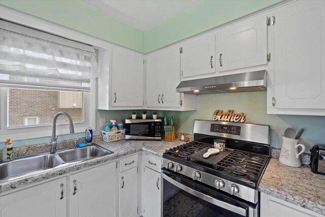 3433 Illinois St, Mount Pleasant, WI 53405 - kitchen with stainless steel appliances, range hood, a sink, and white cabinetry