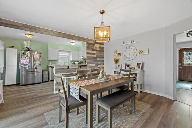 3433 Illinois St, Mount Pleasant, WI 53405 - dining space with a chandelier, wood finished floors, and baseboards