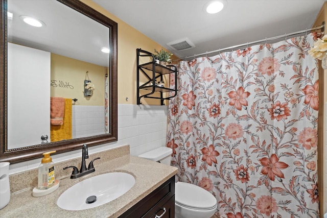 3433 Illinois St, Mount Pleasant, WI 53405 - bathroom featuring tile walls, toilet, vanity, a shower with shower curtain, and recessed lighting