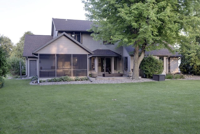 396 Panther Ct, Whitewater, WI 53190 - back of house with a sunroom, a shingled roof, and a yard