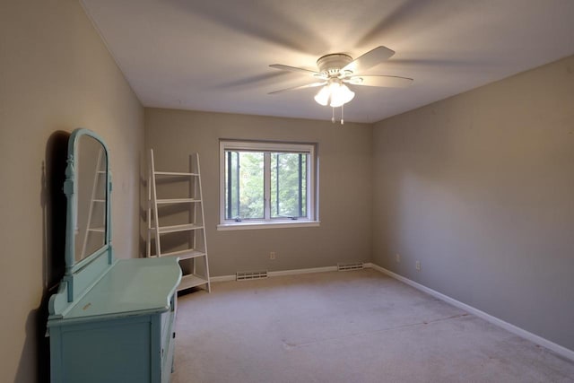 396 Panther Ct, Whitewater, WI 53190 - spare room featuring light carpet, a ceiling fan, and baseboards