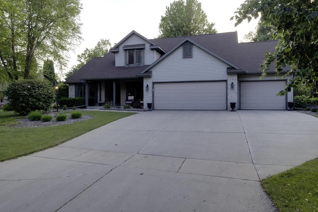 396 Panther Ct, Whitewater, WI 53190 - view of front of property featuring a garage, concrete driveway, a front lawn, a shingled roof, and a porch