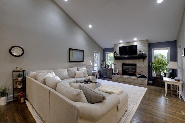 396 Panther Ct, Whitewater, WI 53190 - living area featuring healthy amount of natural light, high vaulted ceiling, recessed lighting, dark wood-style flooring, and a large fireplace