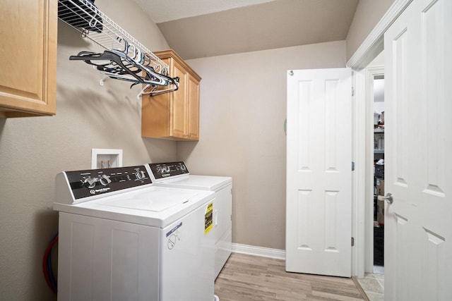 1820 Stoney Ln, Slinger, WI 53086 - laundry room featuring washing machine and clothes dryer, cabinet space, light wood-style floors, and baseboards