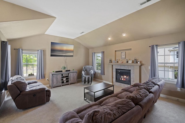1820 Stoney Ln, Slinger, WI 53086 - living room with light carpet, vaulted ceiling, a tiled fireplace, baseboards, and recessed lighting