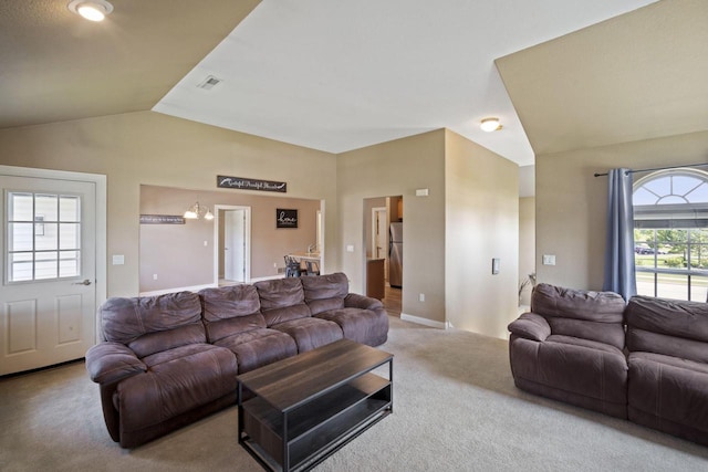 1820 Stoney Ln, Slinger, WI 53086 - carpeted living room with vaulted ceiling and a chandelier