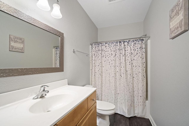 1820 Stoney Ln, Slinger, WI 53086 - bathroom featuring vanity, toilet, wood finished floors, and shower / bath combination with curtain