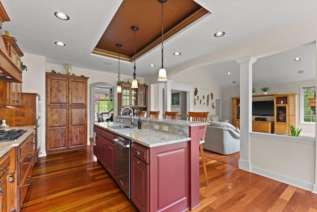 4205 Quarry Springs Dr, Racine, WI 53405 - kitchen with ornate columns, a sink, arched walkways, stainless steel appliances, and a kitchen breakfast bar