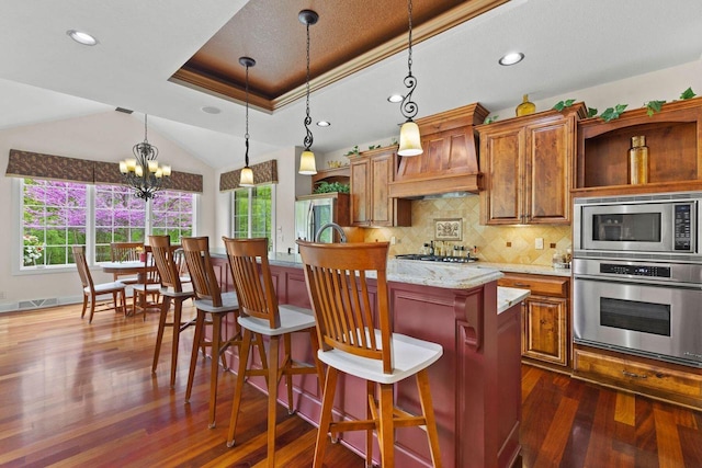 4205 Quarry Springs Dr, Racine, WI 53405 - kitchen with stainless steel appliances, custom range hood, dark wood-style flooring, backsplash, and decorative light fixtures