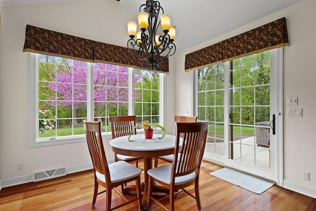 4205 Quarry Springs Dr, Racine, WI 53405 - dining area with wood finished floors, a chandelier, and baseboards