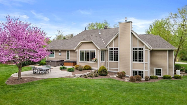 4205 Quarry Springs Dr, Racine, WI 53405 - back of property featuring a hot tub, a patio, a chimney, a yard, and roof with shingles